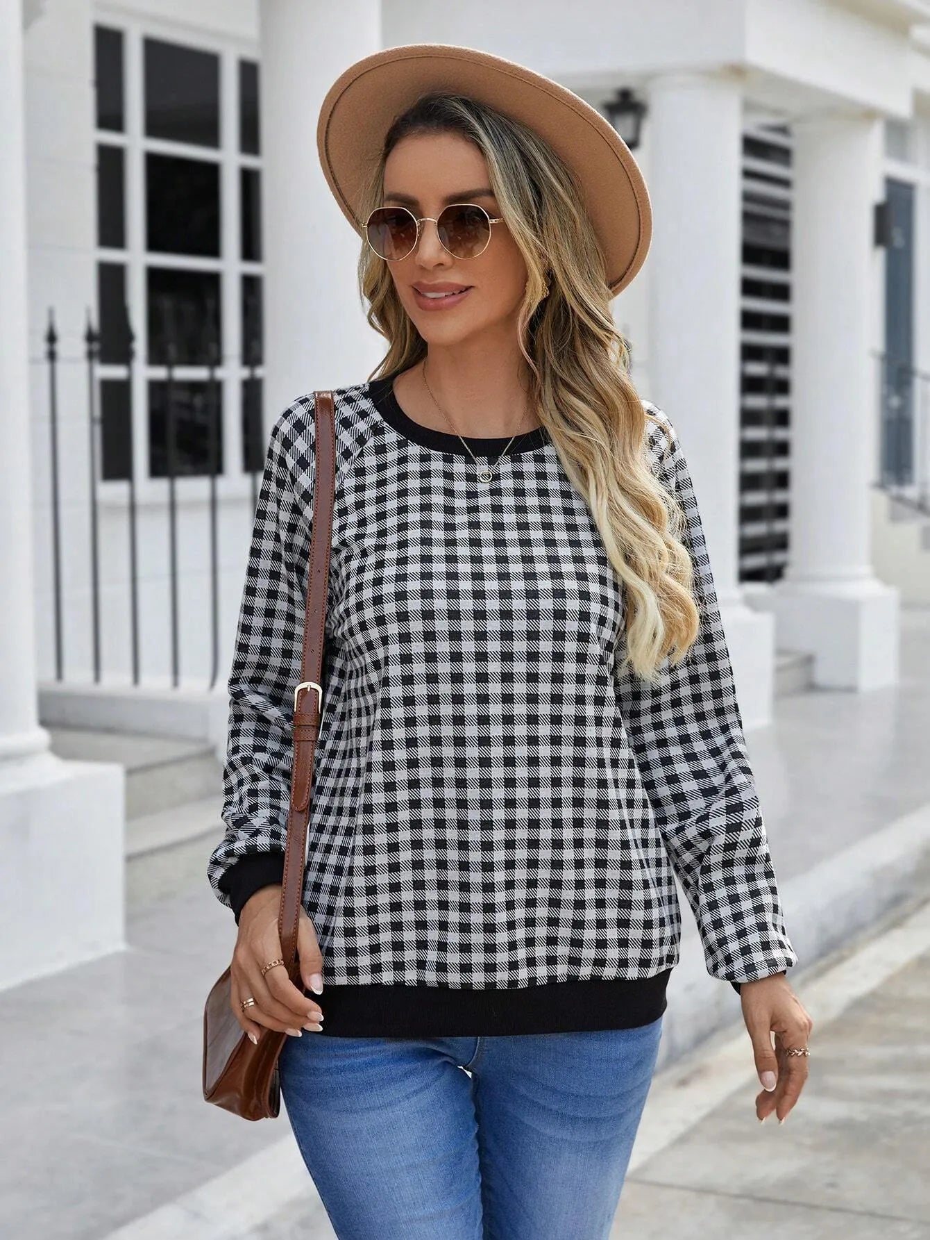 Black long sleeve pullover sweater with printed plaid and stripe pattern.