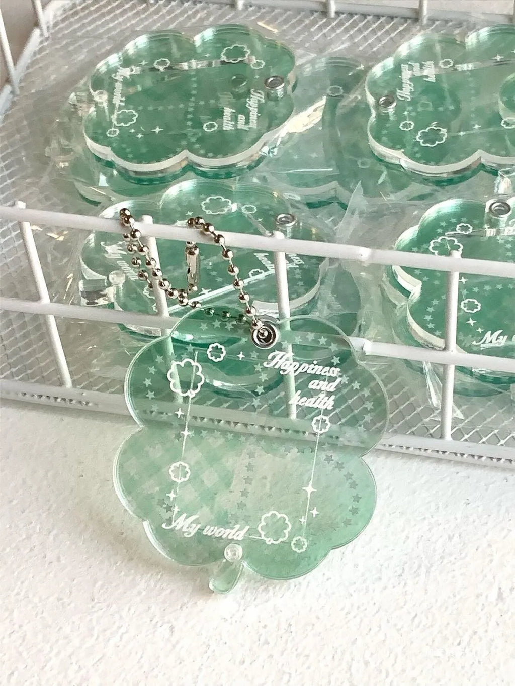 Acrylic four-leaf clover shape keychain pendant for phones in blue, green, or mint.