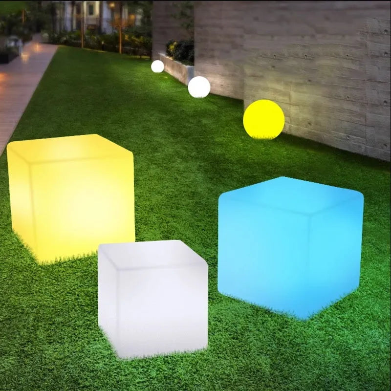 Modern white LED square cube light for outdoor garden and pathway illumination.