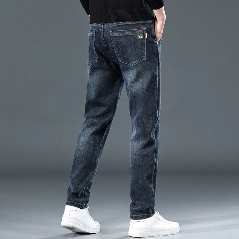 Blue grey slim straight casual trousers with a mid-waist and elastic comfort on a neutral background.