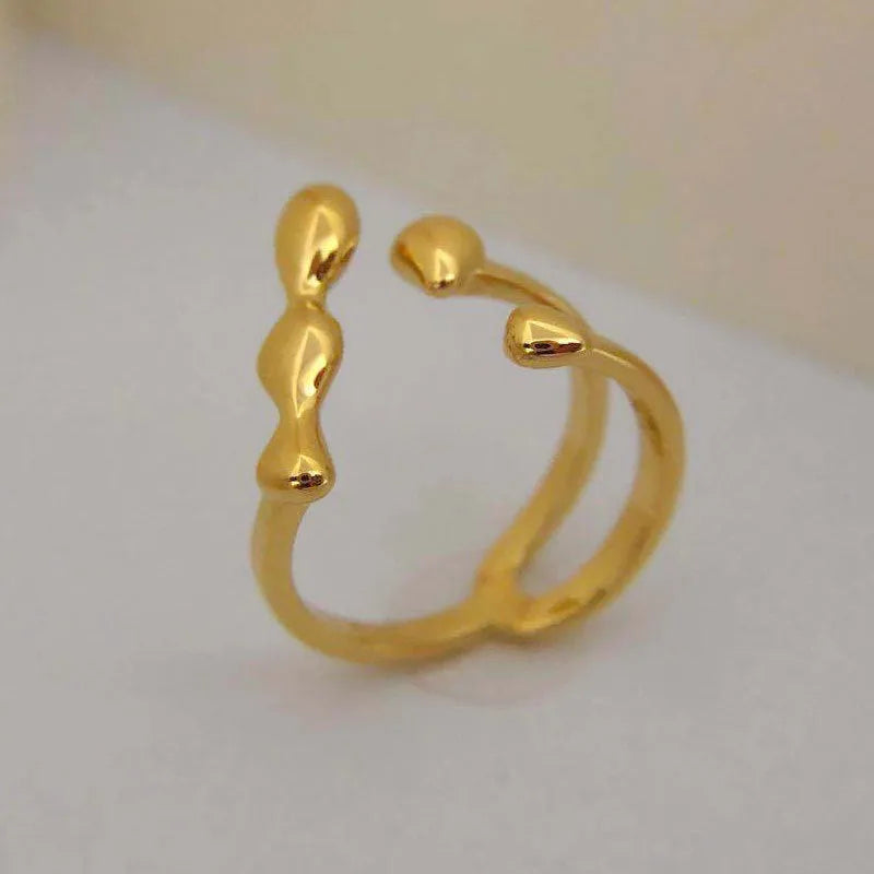 Adjustable brass opening ring with circular sphere element in gold or silver finish