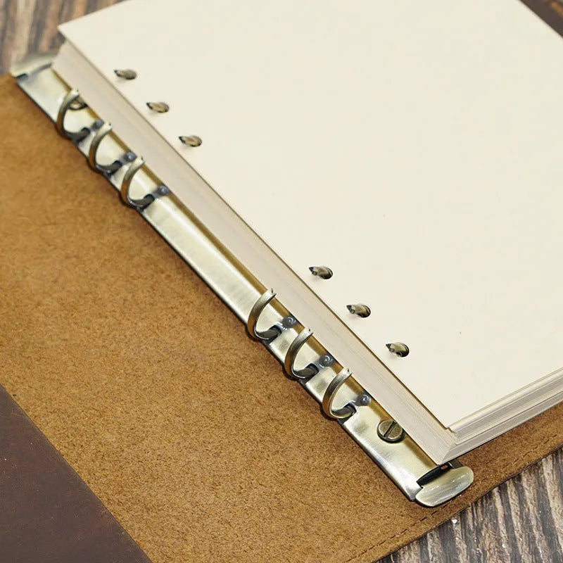 A5 handmade cowhide notebook with genuine leather cover in Crazy Horse Brown, opened on a table