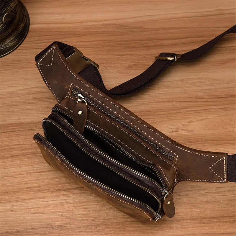 Brown top layer cowhide men's sports waist bag showing pull closure and internal mobile phone pocket