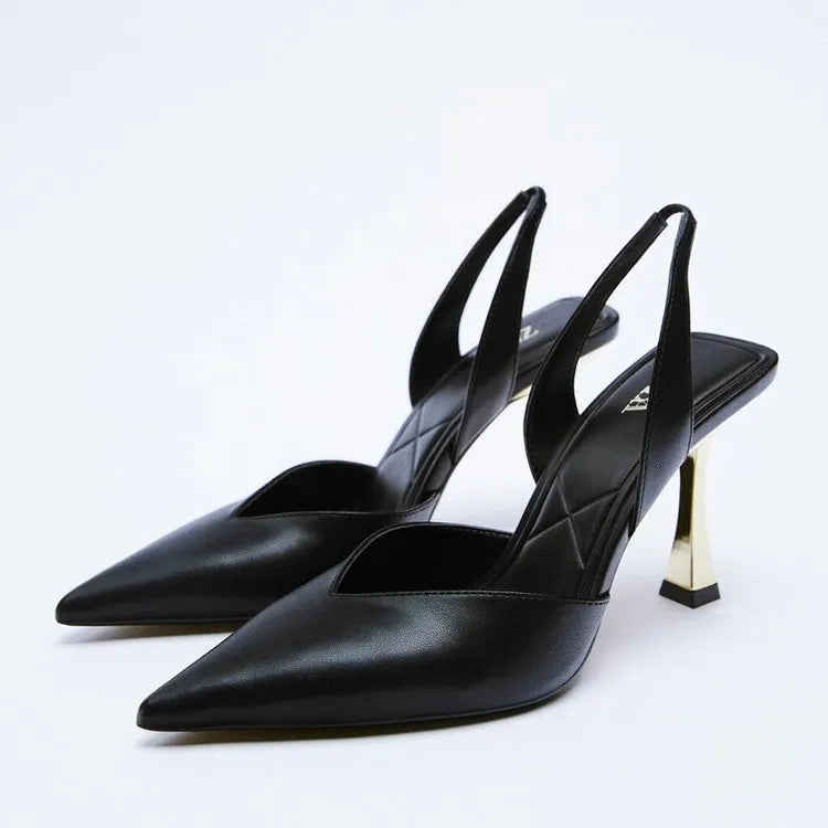 Apricot and black patent leather pointed high heels with a shallow-cut vamp, shown from the side.