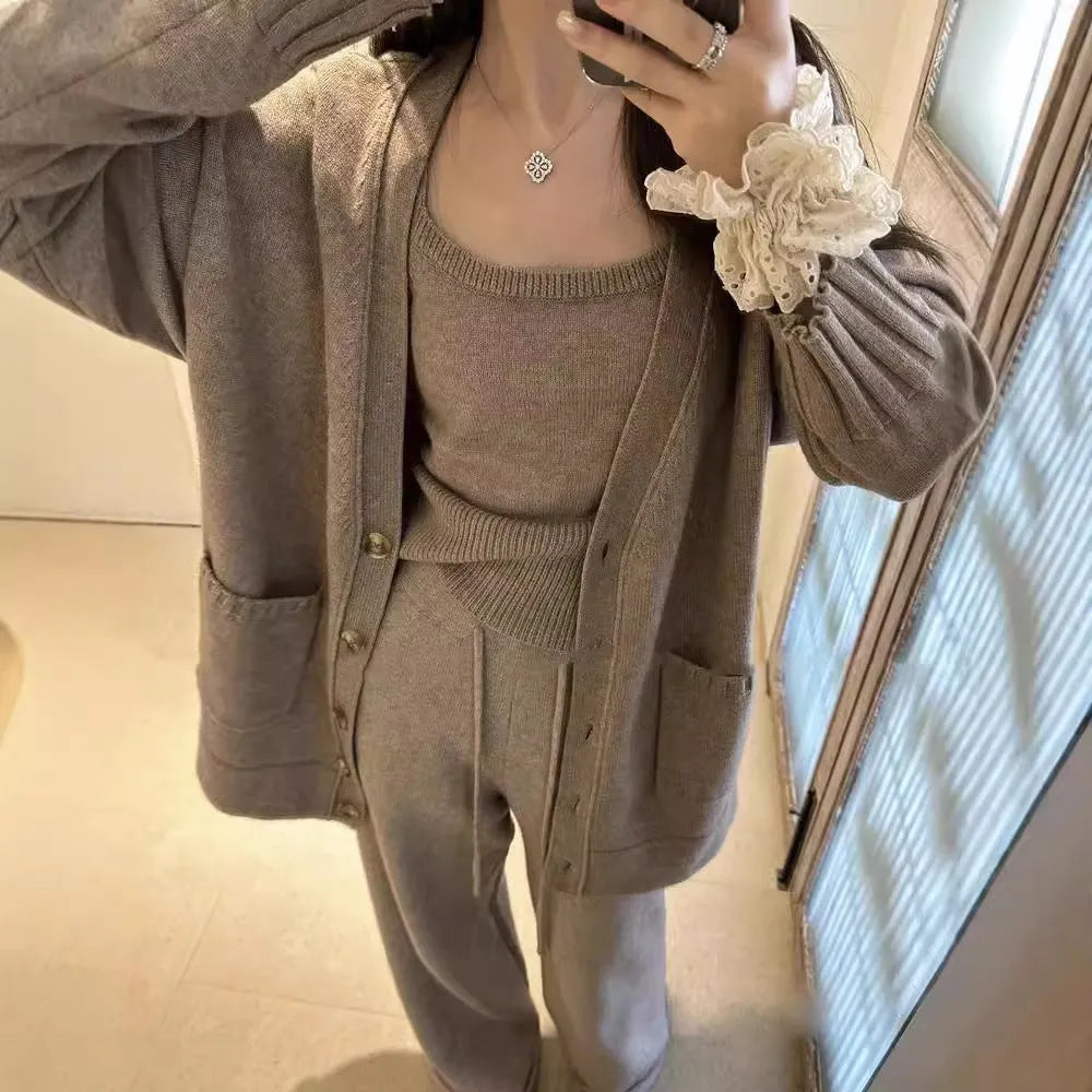 Women's knit three-piece set showing cardigan coat, vest, and suspender trousers in beige colour