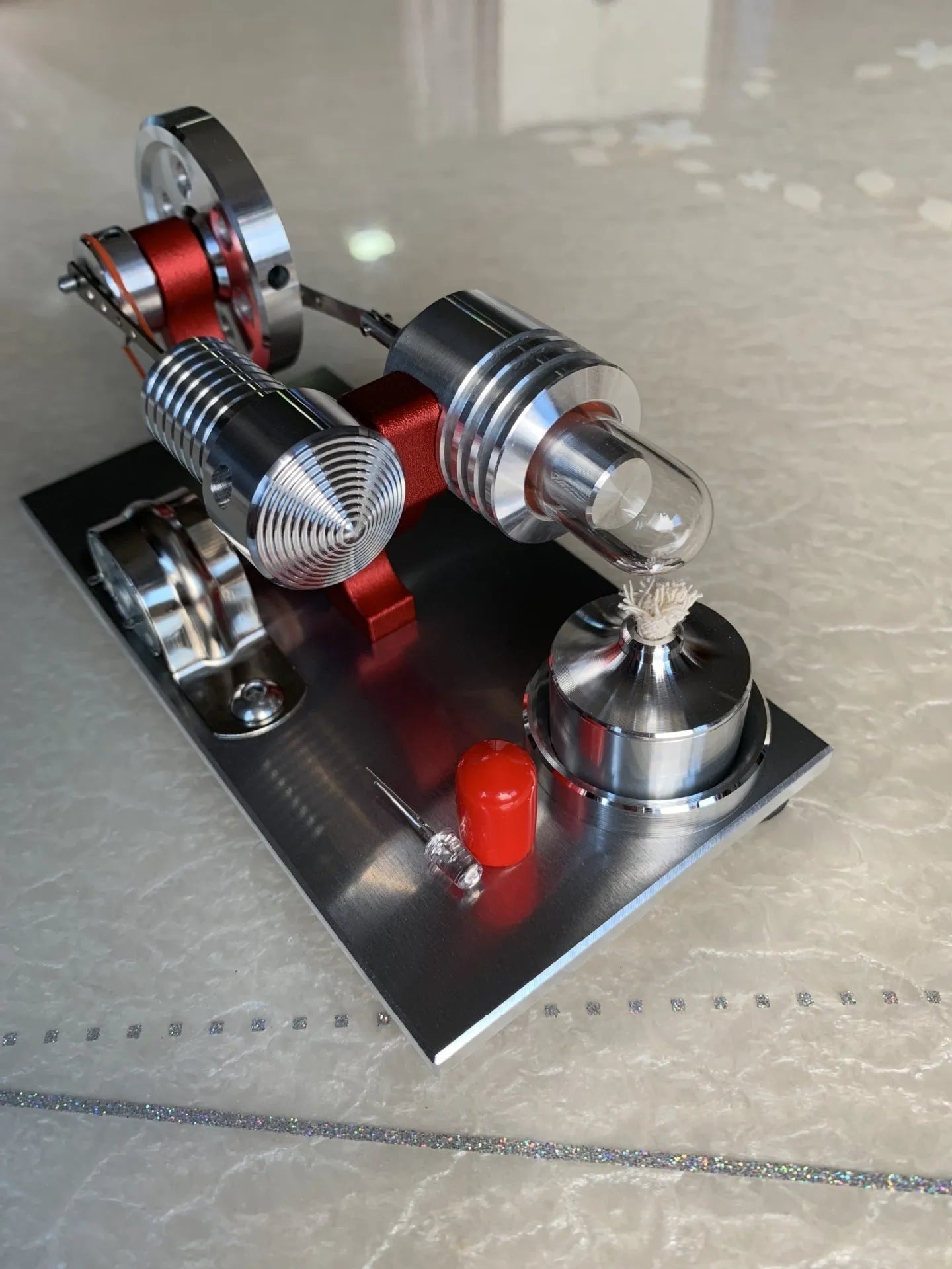 2019 Red upgrade miniature Stirling engine toy on a desk, 155x80x85mm, showing flywheel and cylinder