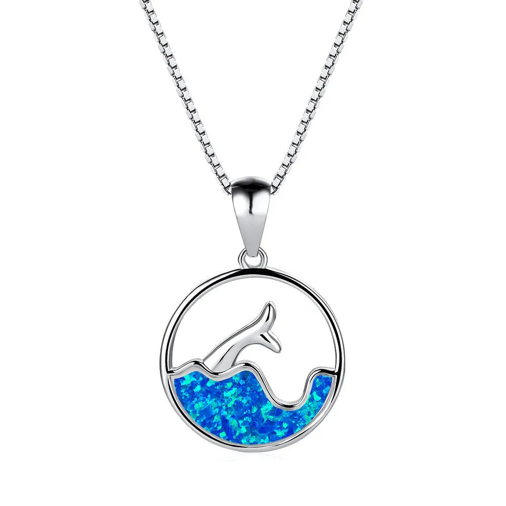 White gold geometric fishtail necklace with a round blue opal pendant on an adjustable chain.