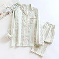 Ladies' red and white striped cotton gauze long-sleeved top and trousers loungewear set laid flat.