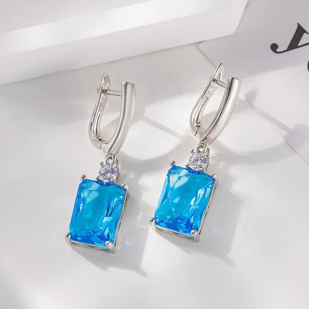A pair of square geometric stud earrings with a quadrilateral design in an electroplated gold or silver finish.