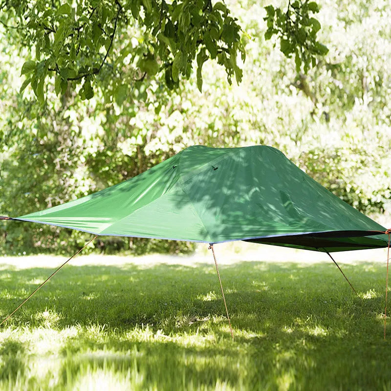 Self-driving tour camping hammock tent with aluminium pole and mosquito net suspended between trees in a forest setting