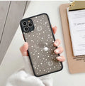 Black and white Star Universe anti-blue light phone case for iPhone models on a table.