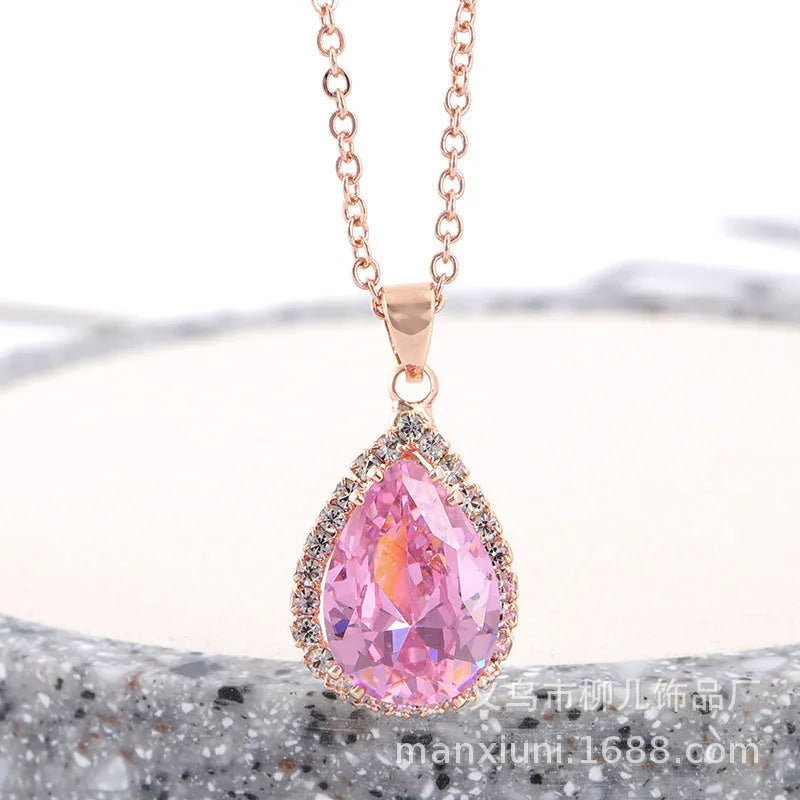 Rose gold water drop shape necklace with rhinestone geometric detailing in pink colour