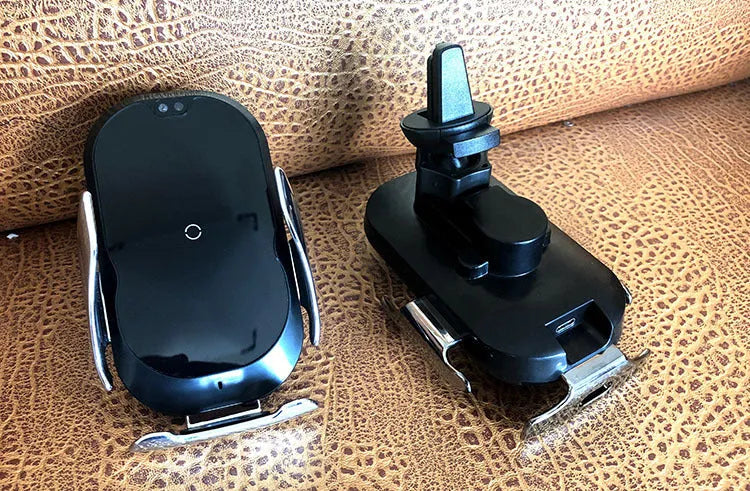 Black 15W smart car phone holder with wireless charging and infrared sensor on car dashboard