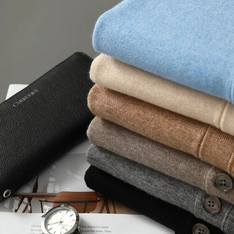 Man wearing a loose V-neck cardigan coat in Andy Velvet fabric, showing the long sleeves and available colour options.