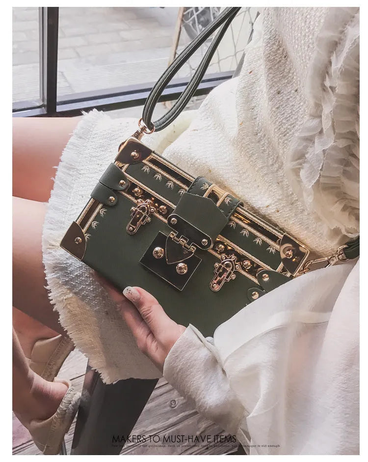 Women's structured shoulder bag with flap closure and adjustable crossbody strap in black or green