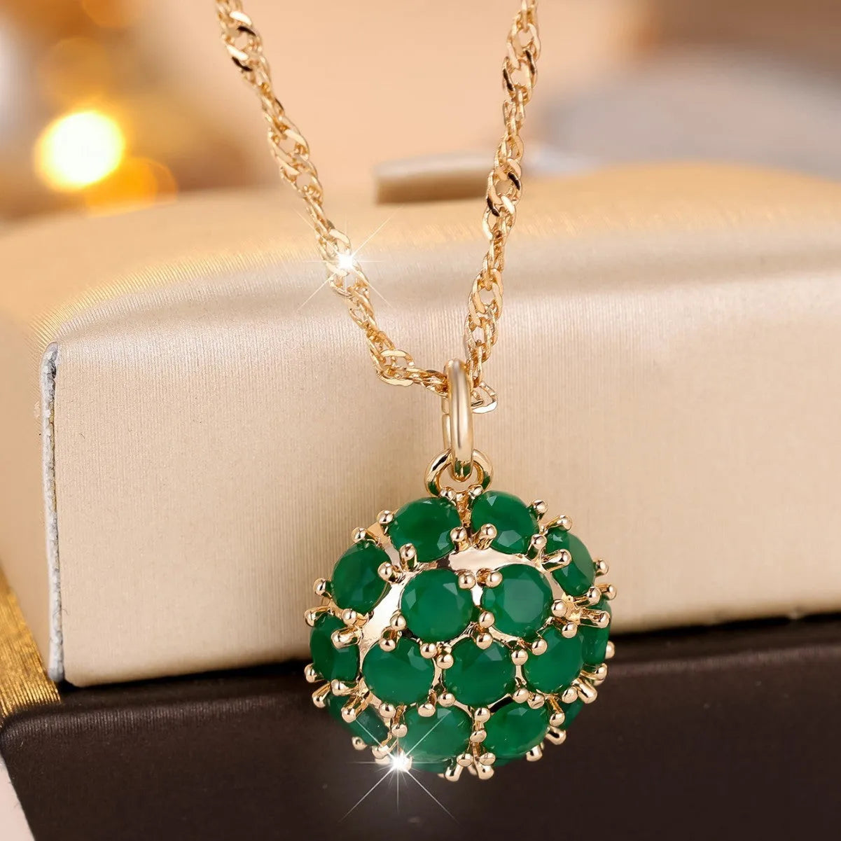 Round emerald diamond necklace with champagne gold electroplated finish on geometric pendant and chain