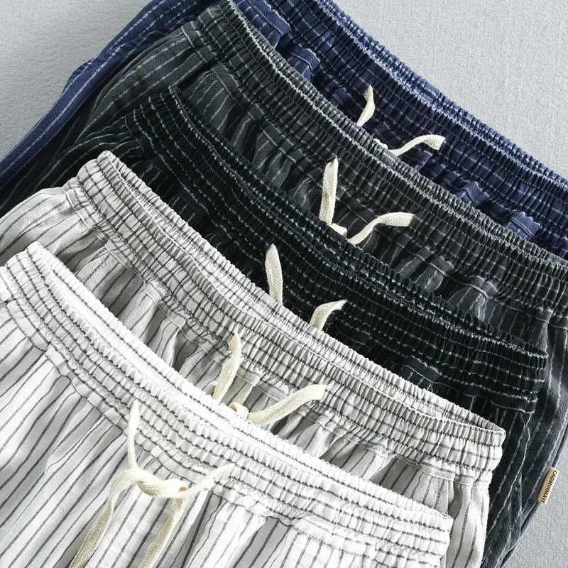 Men's striped cotton casual loose shorts on a hanger showing mid waist and shorts length.