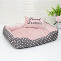 Polka dot printed square dog bed with a matching embroidery pillow in rose red, shown in a small size.