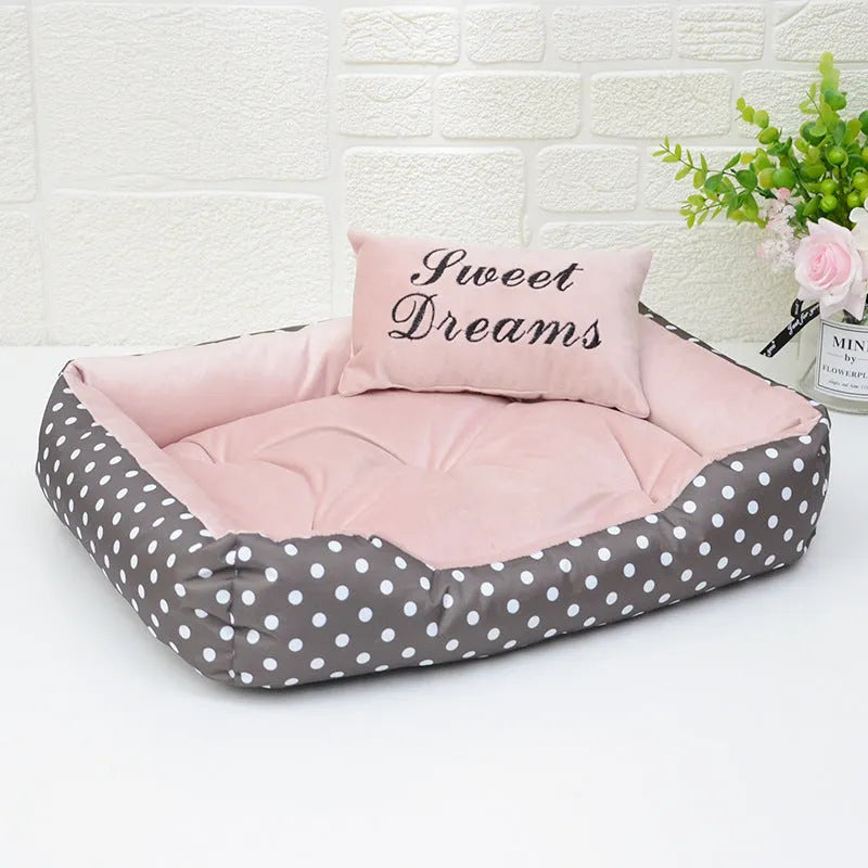 Polka dot printed square dog bed with a matching embroidery pillow in rose red, shown in a small size.