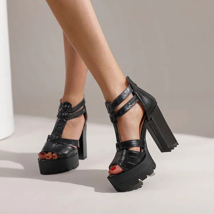 Women's black platform high heel sandals with ankle strap and back zipper on a round toe.