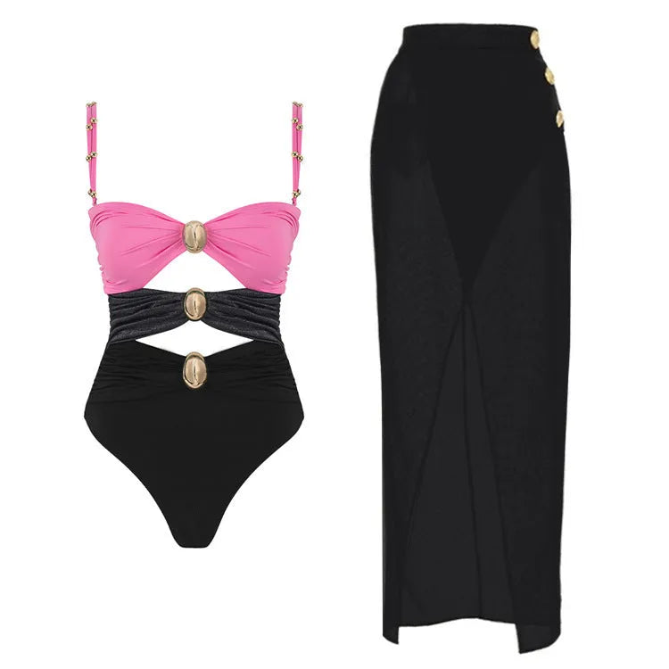 Women's solid colour one-piece swimsuit with matching skirt and gold button detail.
