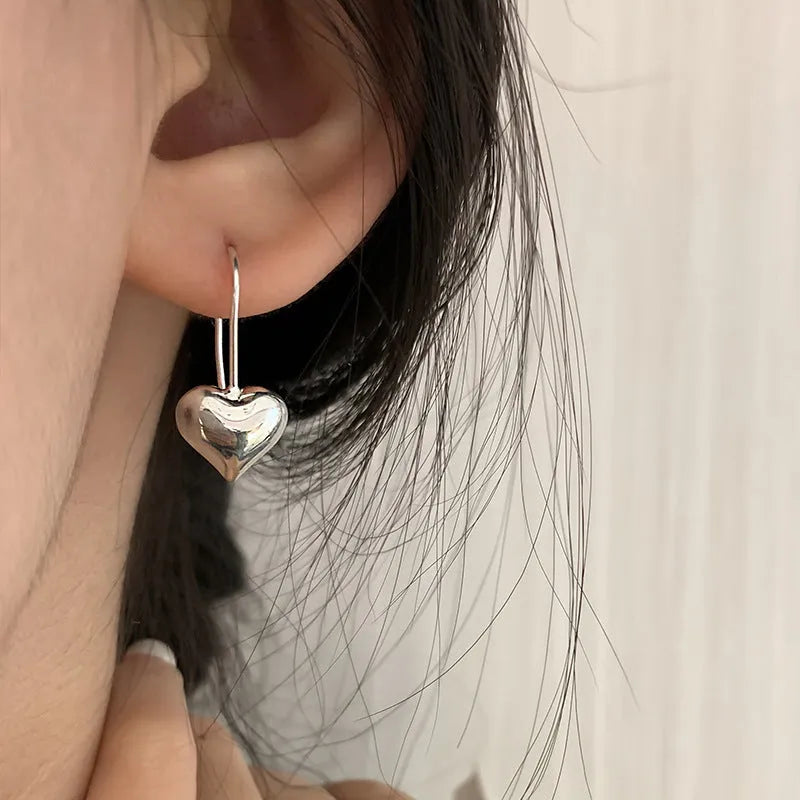 Silver heart earrings with glossy three-dimensional design and Korean style ear hooks