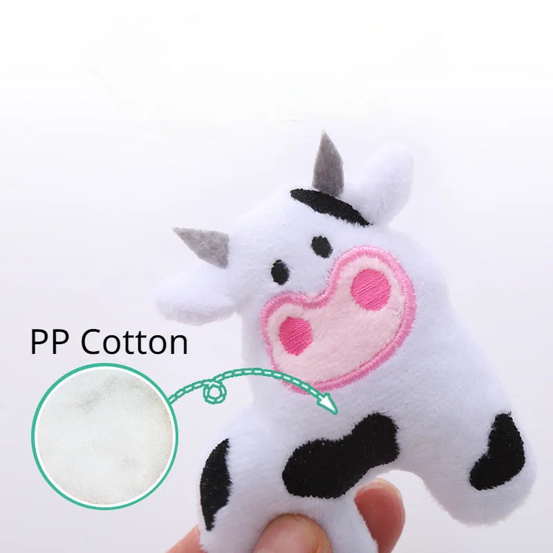 Colourful plush cat toy shaped like a cow, a crocodile, or a parrot on a plain background.