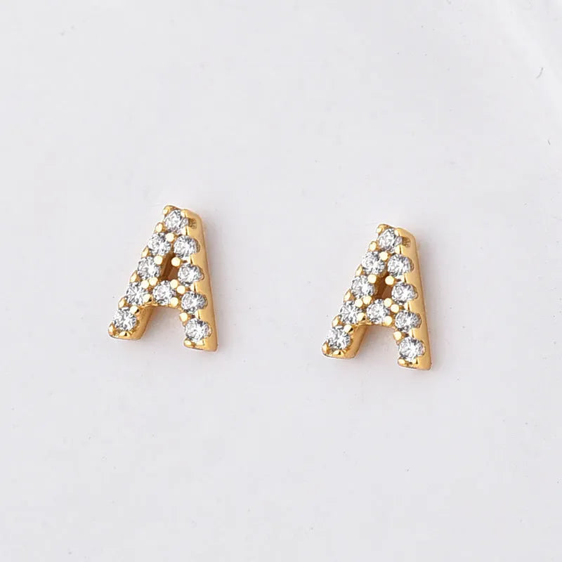 Gold plated alphabet letter earrings with zircon details showing English character design