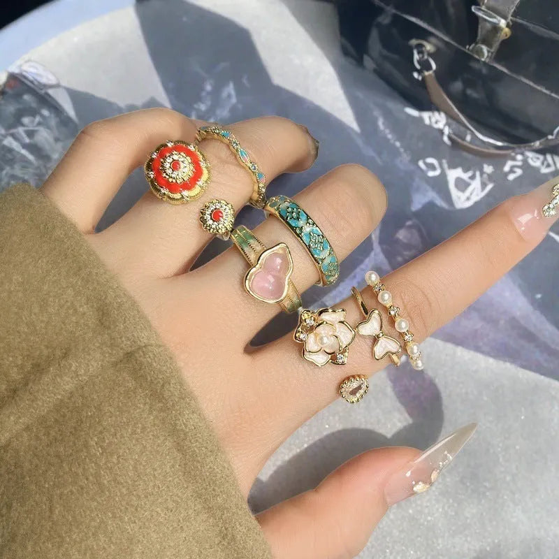 Adjustable copper vintage gourd ring with inlaid zircon stones showing floral and bow design elements