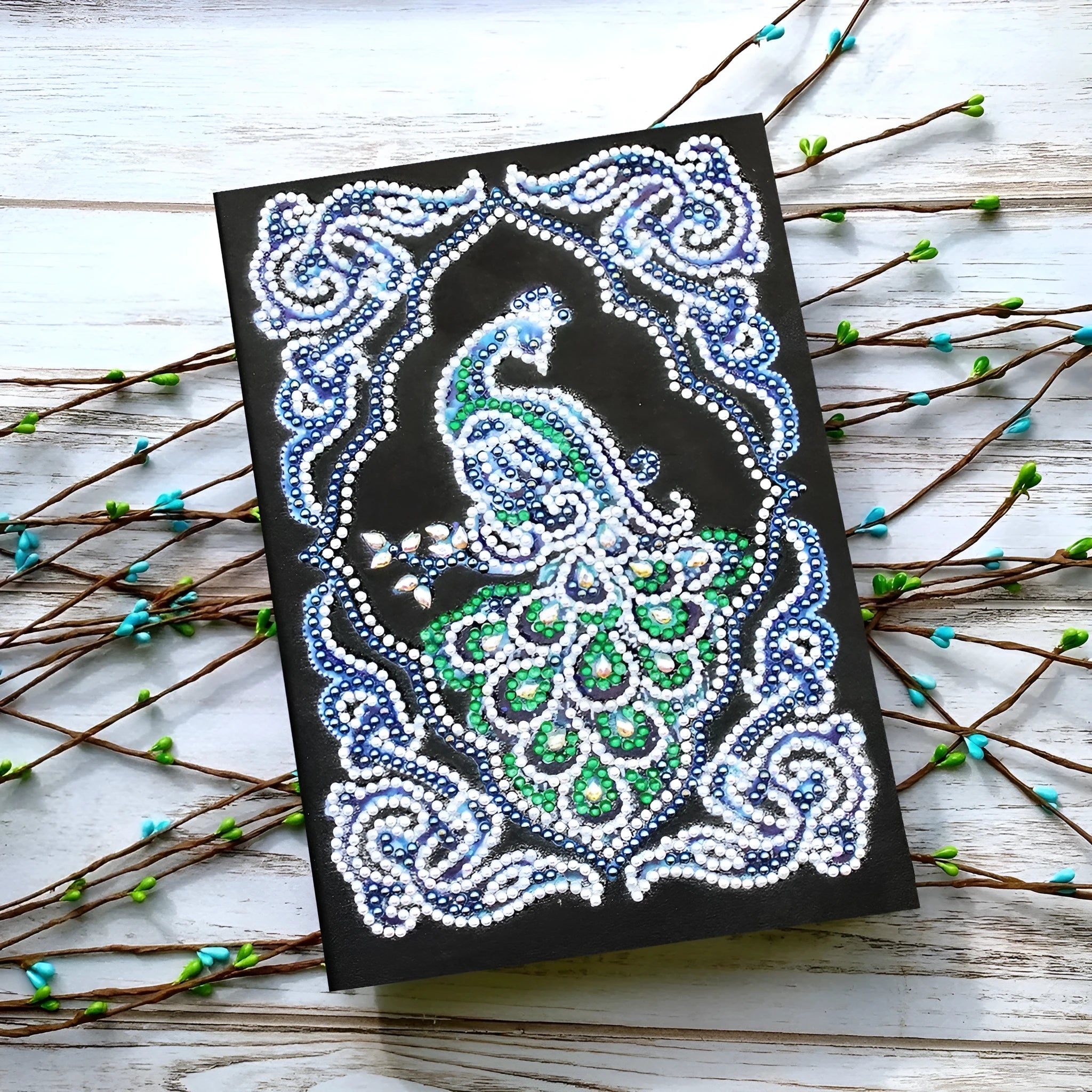 Black A5 diamond painting notebook with peacock design showing shaped and bright drills