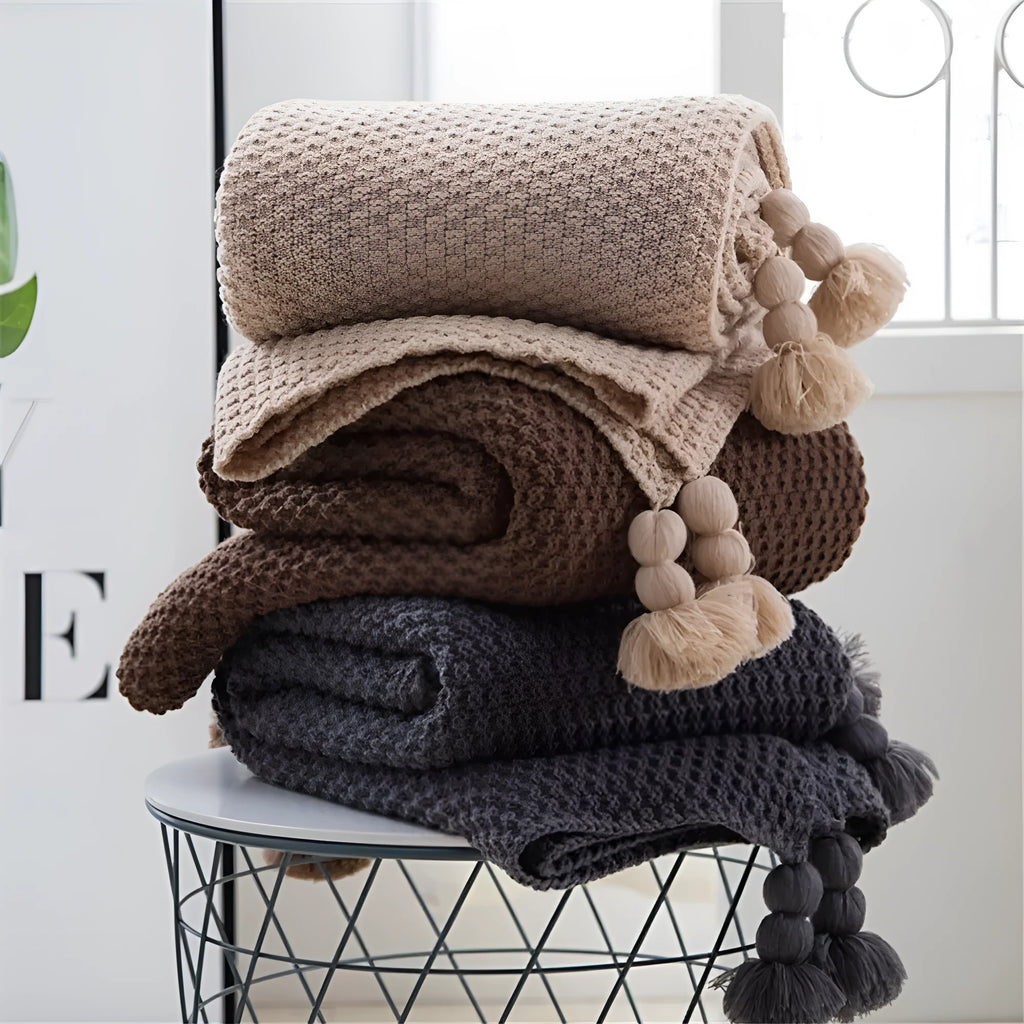 Nordic fringed knit ball blanket in beige colour showing textured design