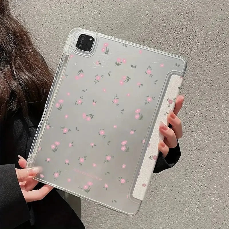 Transparent tri-fold iPad case with floral cartoon pattern, shown in standing position with magnetic closure