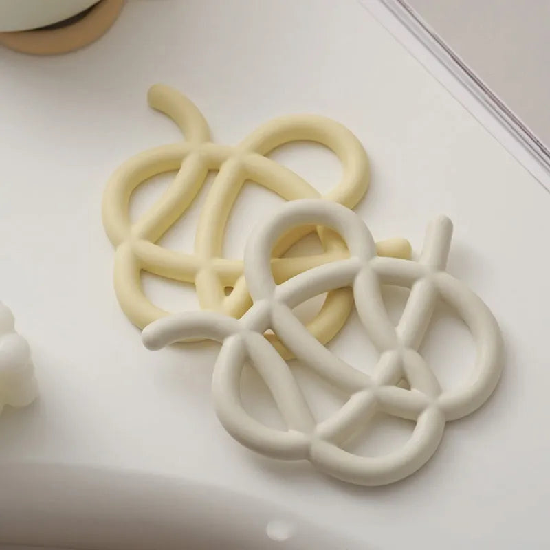 Ceramic heat proof mat with irregular shape and bend and hook design