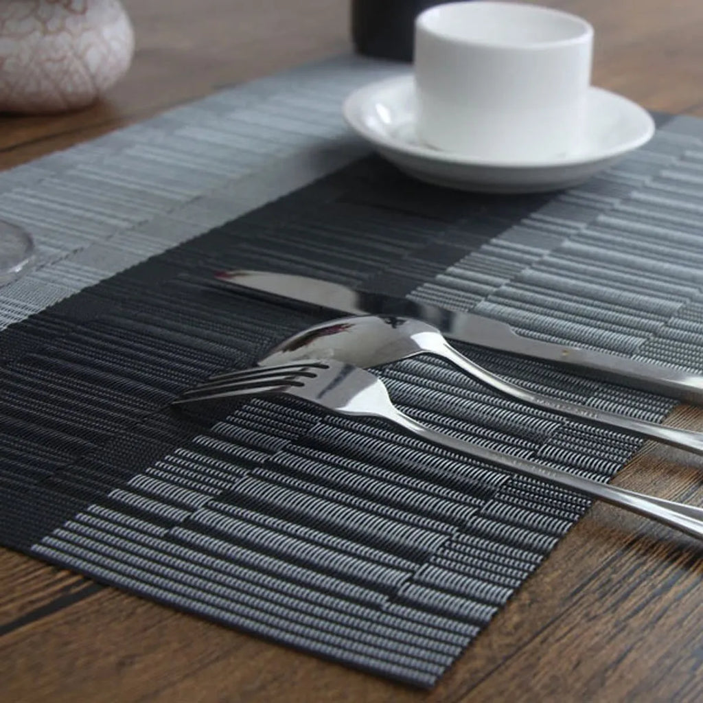 Non-slip PVC place mat in modern simple style, showing gradient bamboo black colour option on a kitchen counter.