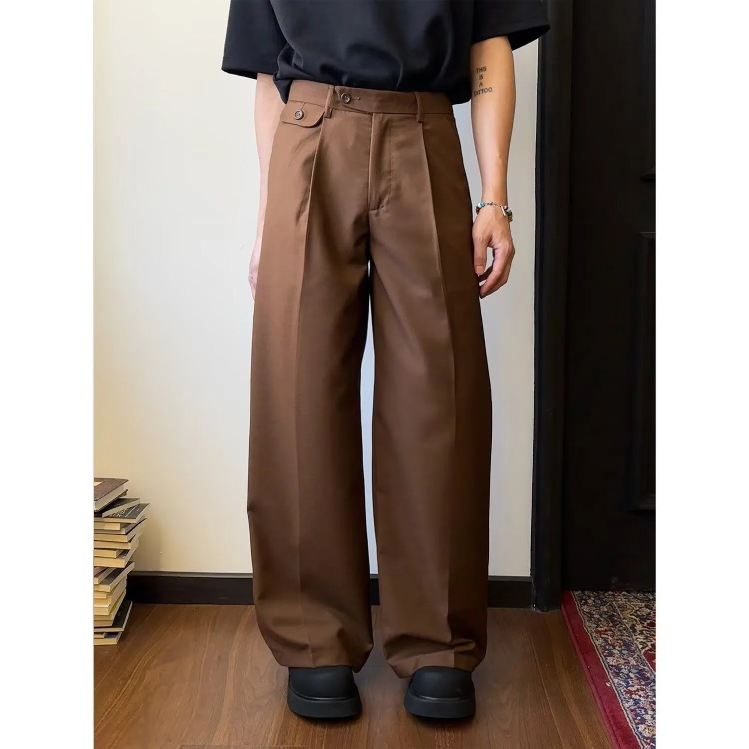 Man wearing straight-leg loose fit casual trousers in brown, showcasing the drape and fit.