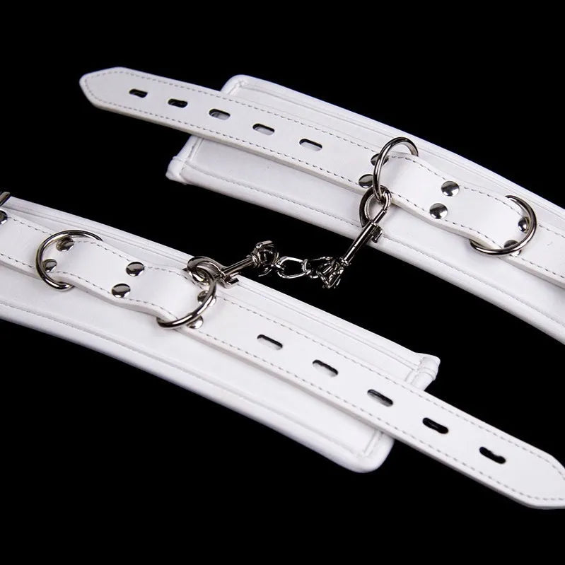 White PU sponge bondage restraint set showing handcuffs, footcuffs and neck cuff accessories