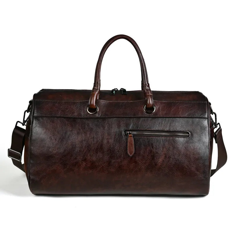 Handmade retro style leather travel bag in vintage brown colour showing expansion functionality