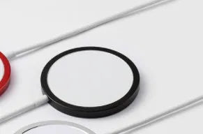 Silver metal Magsafe magnetic wireless charger for iPhone showing magnetic ring.