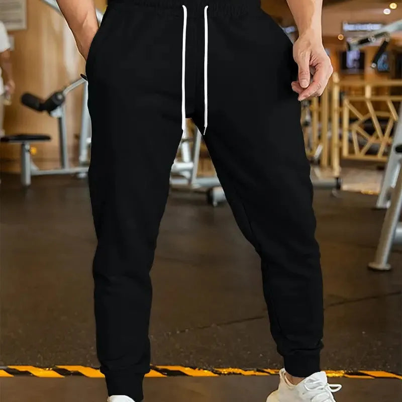 Men's polyester leisure trousers with elastic lace closure and drawstring waist in loose fit design