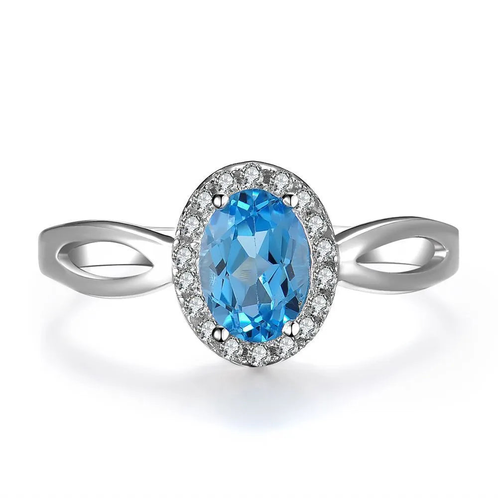 Four-piece 925 sterling silver jewellery set with blue topaz stones: geometric necklace, earrings, ring, and pendant.