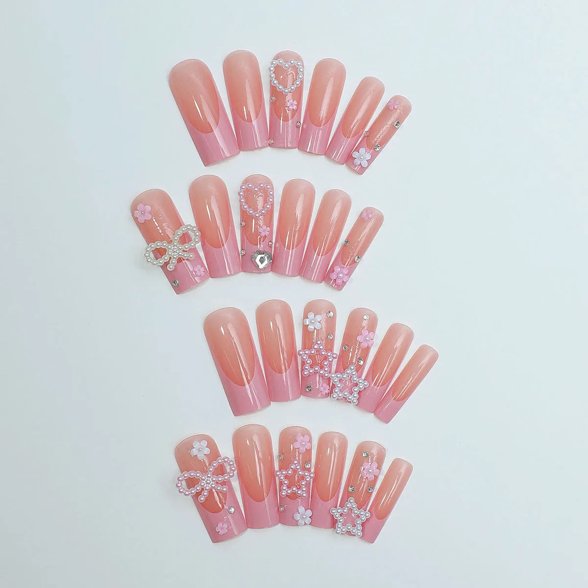 Super long water pipe shaped false nails with a French spot design and decorative bow accent.