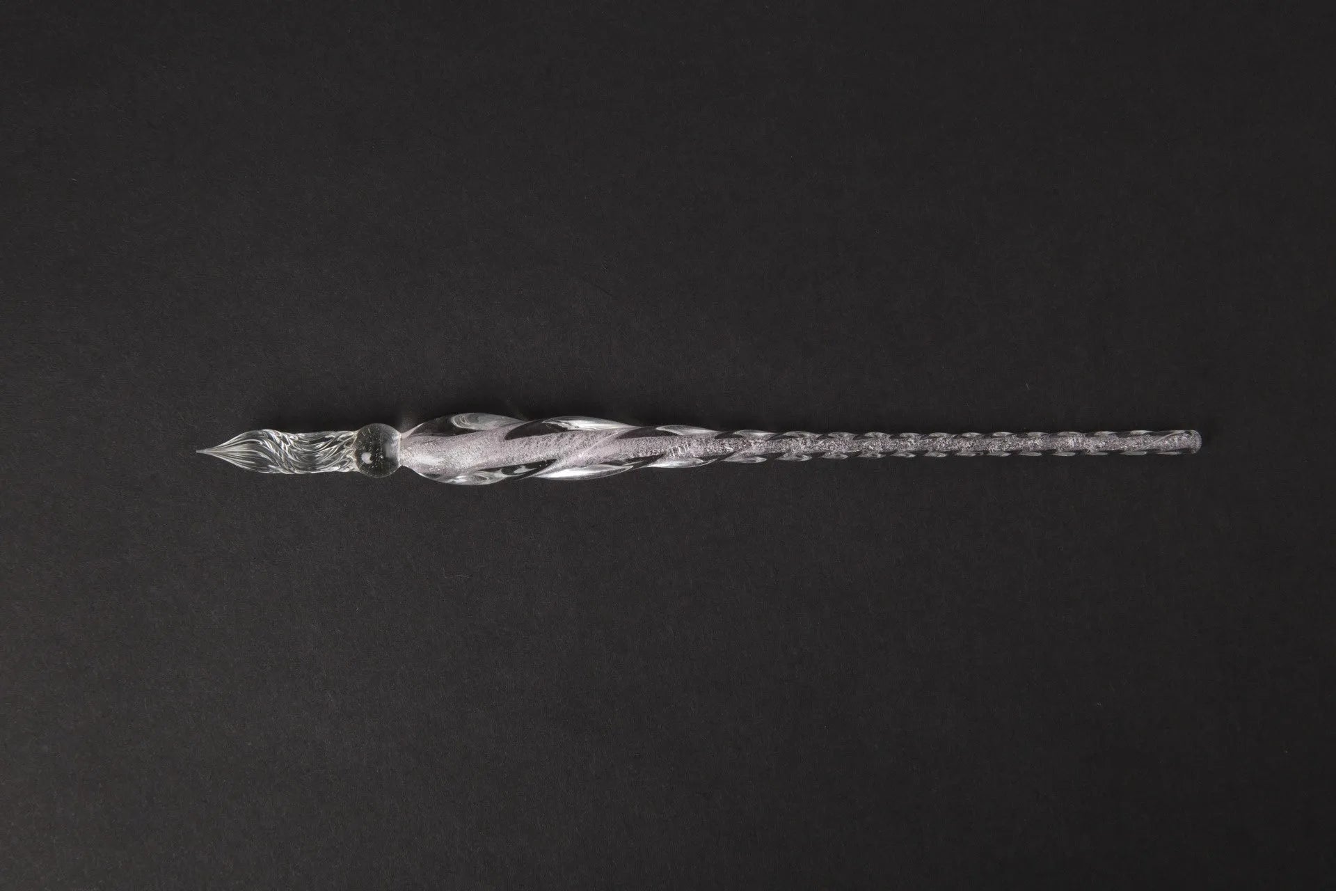 Transparent glass art pen with coloured ink dipped design in a gift box.