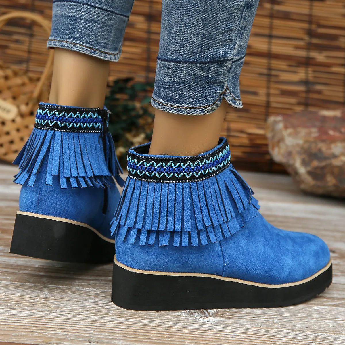 Women's dark brown suede wedge ankle boots with a side zipper and decorative tassel.