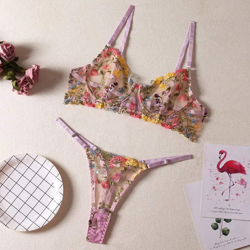 Floral patterned mesh bra with steel ring T-back in various colours on a mannequin.