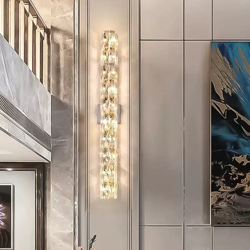 Modern crystal and stainless steel wall lamp in chrome finish with LED lighting.