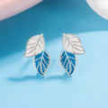 White gold plated copper leaf-shaped stud earrings for women on white background