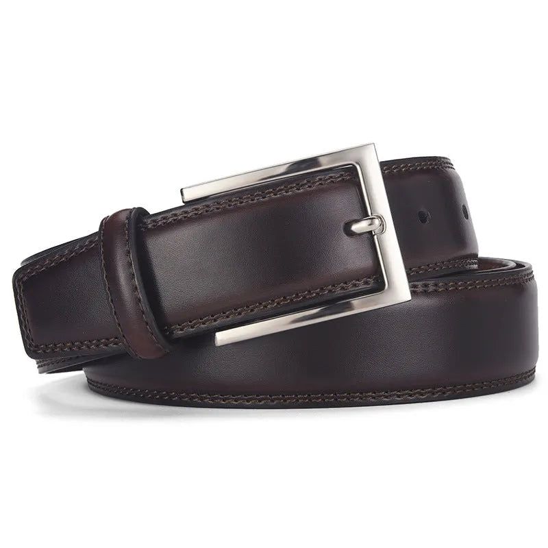 Men's black genuine leather belt with a silver alloy pin buckle on a flat surface