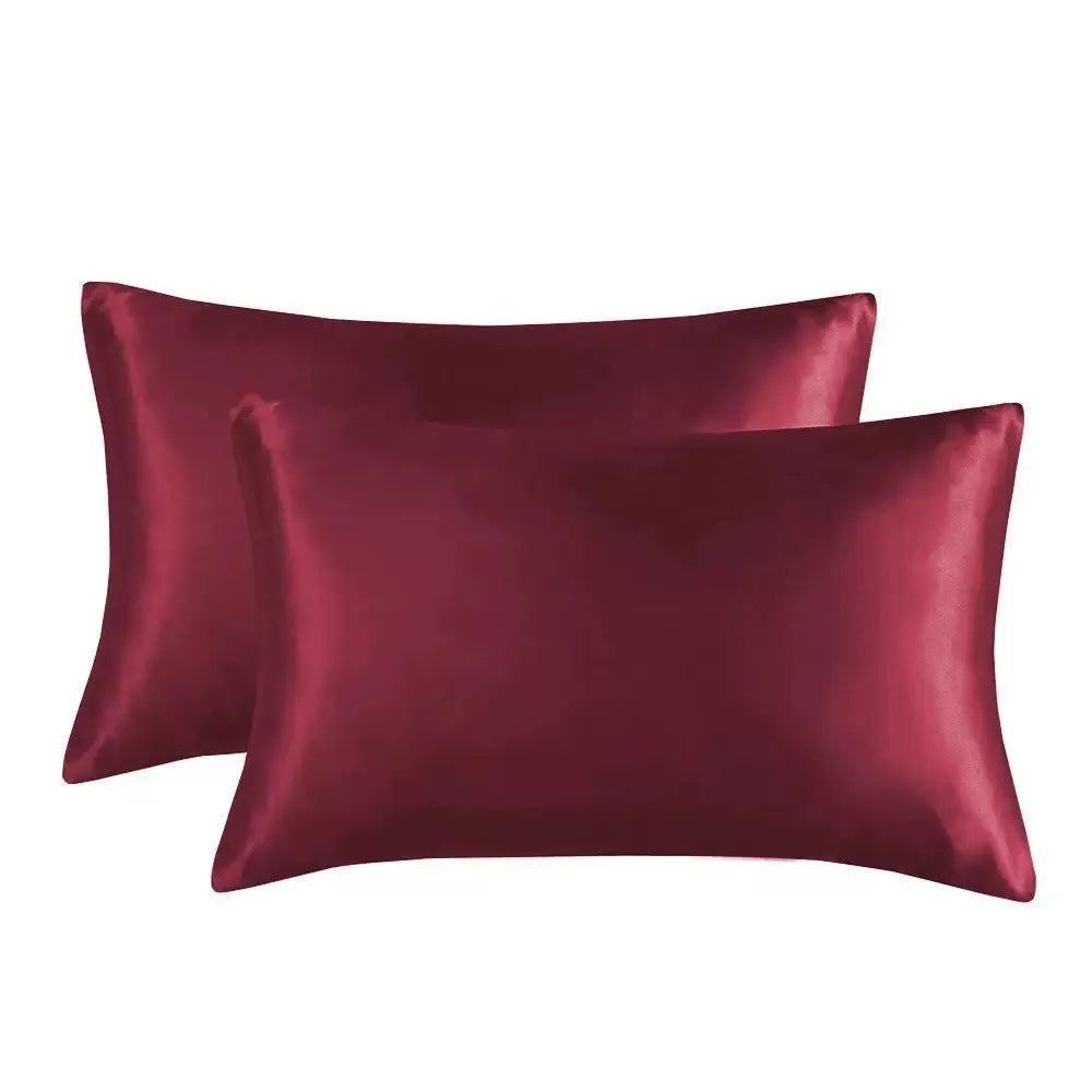 A pair of solid colour satin pillowcases in a chosen shade, showing the smooth plain weave fabric texture.