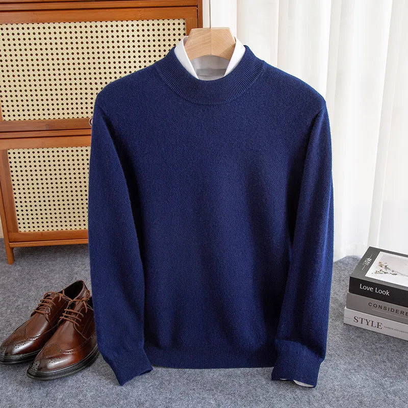 Man wearing a loose-fit, chunky knit wool sweater with a half-turtleneck collar in a neutral colour.