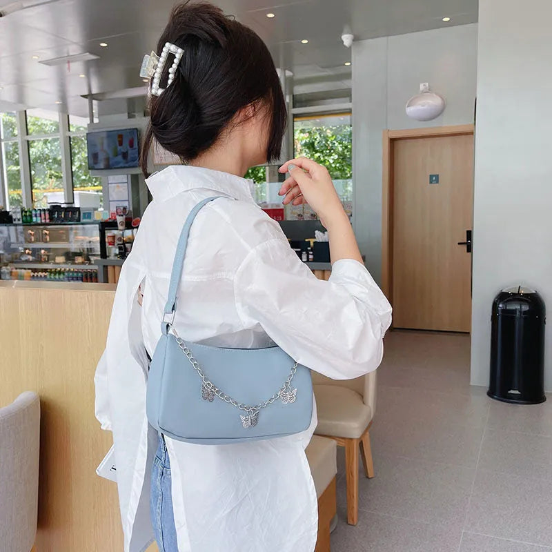 PU leather retro chain underarm bag in horizontal square shape showing crossbody strap and organised interior.